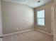 Bedroom featuring neutral carpet and walls, and window at 2141 Spikerush Way, Buford, GA 30519