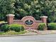 Brick Mill Creek Lakes entrance sign surrounded by lush greenery and landscaping, adding a touch of elegance at 2141 Spikerush Way, Buford, GA 30519