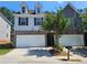 Charming two-story home featuring a two-car garage, brick accents, and a well-maintained front yard at 2141 Spikerush Way, Buford, GA 30519