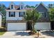 Charming two-story home featuring a two-car garage, brick accents, and a well-maintained front yard at 2141 Spikerush Way, Buford, GA 30519