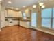 Bright kitchen with hardwood floors, granite countertops, stainless steel appliances, and ample natural light at 2141 Spikerush Way, Buford, GA 30519