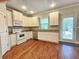 Well-lit kitchen with white cabinets and stainless steel appliances at 2141 Spikerush Way, Buford, GA 30519