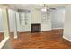Bright living room with hardwood floors, fireplace with built-in shelving, and ample natural light at 2141 Spikerush Way, Buford, GA 30519