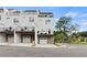 Townhome rear exterior with balcony, garage access, and landscaped surroundings at 2535 Astaire Ct, Atlanta, GA 30318