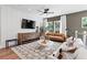 Stylish living room with hardwood floors, shiplap accent wall, modern furniture, and ample natural light at 2535 Astaire Ct, Atlanta, GA 30318