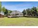 Large backyard featuring a well-maintained lawn, mature trees, and a cozy deck and porch at 33 Evans Point Pt, Dallas, GA 30157