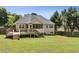 Private backyard showcasing a spacious deck, screened-in porch, and lush green grass at 33 Evans Point Pt, Dallas, GA 30157