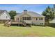 A large, fenced backyard with a wooden deck and screened in porch at 33 Evans Point Pt, Dallas, GA 30157