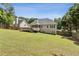 A long, green backyard with a wooden fence, deck, and screened in porch at 33 Evans Point Pt, Dallas, GA 30157