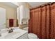 Cozy bathroom featuring a vanity with an oval sink, toilet, and patterned shower curtain for privacy at 33 Evans Point Pt, Dallas, GA 30157