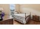 Bedroom with four-post bed, wood floors and a bright, sun-filled window at 33 Evans Point Pt, Dallas, GA 30157
