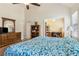 Vaulted ceiling bedroom with blue bedspread, walk in closet and adjoining office space at 33 Evans Point Pt, Dallas, GA 30157