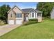 Charming two-story home features a well-manicured lawn and a two-car garage at 33 Evans Point Pt, Dallas, GA 30157