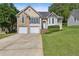 Charming two-story home features a well-manicured lawn and a two-car garage at 33 Evans Point Pt, Dallas, GA 30157