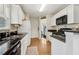 Kitchen with stainless steel sink, white cabinets, and black countertops at 33 Evans Point Pt, Dallas, GA 30157