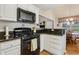 Kitchen featuring granite counters, white cabinets, stainless oven and microwave at 33 Evans Point Pt, Dallas, GA 30157