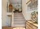 Inviting foyer features carpeted stairs, a wooden railing, and views into the open floor plan at 33 Evans Point Pt, Dallas, GA 30157