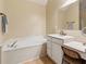 Bright bathroom featuring a soaking tub, vanity, and ample space for relaxation at 33 Evans Pt, Dallas, GA 30157