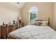 Bedroom showcasing a large window, wooden furniture, and comfortable bed with patterned bedding at 33 Evans Pt, Dallas, GA 30157