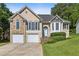 Charming home with stone accents, two-car garage, landscaped yard, and inviting front entrance at 33 Evans Pt, Dallas, GA 30157