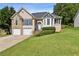Charming two-story home with a manicured lawn, a two-car garage, and stone facade accents at 33 Evans Pt, Dallas, GA 30157