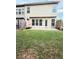View of the backyard with a concrete patio and well-maintained lawn at 5850 Shiloh Woods Dr, Cumming, GA 30040