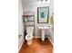 Powder room with wood floors, vanity, and decor at 5850 Shiloh Woods Dr, Cumming, GA 30040