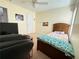 A cozy bedroom features neutral walls, a ceiling fan, and plush carpet floors at 5850 Shiloh Woods Dr, Cumming, GA 30040