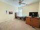 Comfortable bedroom with a ceiling fan, neutral colored walls, and plush carpet flooring at 5850 Shiloh Woods Dr, Cumming, GA 30040