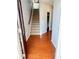 Foyer view of staircase and hardwood floors as seen from the front door at 5850 Shiloh Woods Dr, Cumming, GA 30040