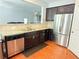 Updated kitchen featuring granite counters, stainless steel appliances and dark wood cabinets at 5850 Shiloh Woods Dr, Cumming, GA 30040