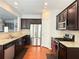 A spacious kitchen featuring stainless steel appliances, granite countertops, and dark cabinets at 5850 Shiloh Woods Dr, Cumming, GA 30040