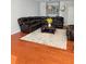 Cozy living room featuring a leather sectional sofa and a decorative area rug at 5850 Shiloh Woods Dr, Cumming, GA 30040