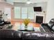 Living room with fireplace, hardwood floors, and large windows at 5850 Shiloh Woods Dr, Cumming, GA 30040