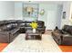 Open living room featuring a leather sofa, wood floors, and decor at 5850 Shiloh Woods Dr, Cumming, GA 30040