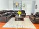 Open living room featuring a leather sofa, wood floors, and decor at 5850 Shiloh Woods Dr, Cumming, GA 30040