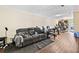 Basement with a gray reclining sofa, wood-look flooring, and plenty of space for activities at 105 North River Dr # A, Atlanta, GA 30350