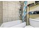 Bathroom features a tub and shower combination with tiled walls and a shower caddy for toiletries at 105 North River Dr # A, Atlanta, GA 30350
