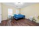 Bright bedroom with wood floors, two windows, and ample space for a bed and other furniture at 105 North River Dr # A, Atlanta, GA 30350