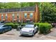 Street view of townhomes, landscaping, and parked cars showing available parking and neighborhood vibe at 105 North River Dr # A, Atlanta, GA 30350