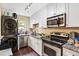 Modern kitchen featuring stainless steel appliances, granite counters, and sleek white cabinetry at 105 North River Dr # A, Atlanta, GA 30350