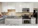 Bright kitchen featuring white cabinets, granite countertops, and stainless steel appliances at 105 North River Dr # A, Atlanta, GA 30350