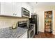 Efficient kitchen with granite countertops, stainless steel appliances, and ample cabinet space at 105 North River Dr # A, Atlanta, GA 30350