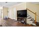 Open living space with wood floors, staircase, and media center perfect for entertaining or relaxing at 105 North River Dr # A, Atlanta, GA 30350