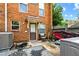 A brick patio with some personal items on it, leading to an exterior door and some nearby foliage at 105 North River Dr # A, Atlanta, GA 30350