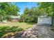 Spacious backyard featuring a shed, lush greenery, and a stone pathway at 1544 Brewer Sw Blvd, Atlanta, GA 30310