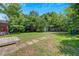 Expansive backyard with mature trees and a shed, providing ample space for recreation at 1544 Brewer Sw Blvd, Atlanta, GA 30310
