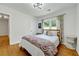 Well-lit bedroom with wood floors, a decorative blanket and view to the hall at 1544 Brewer Sw Blvd, Atlanta, GA 30310