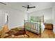 Bright bedroom with hardwood floors, a brass bed, and a ceiling fan at 1544 Brewer Sw Blvd, Atlanta, GA 30310