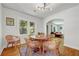 Cozy dining room featuring a modern light fixture, hardwood floors, and arched doorways at 1544 Brewer Sw Blvd, Atlanta, GA 30310